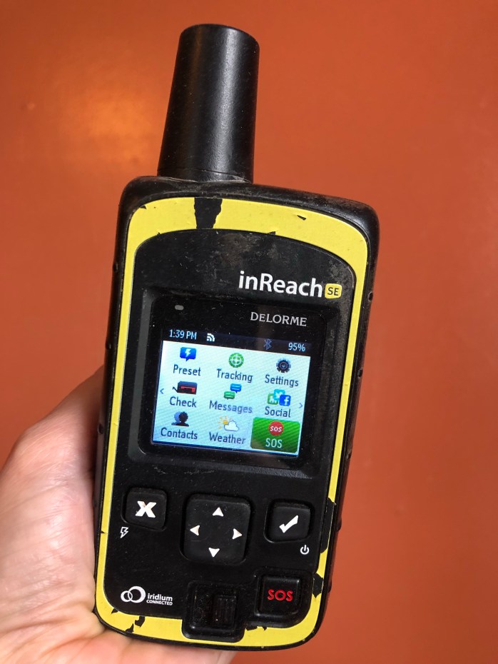A Garmin InReach Delorme satellite communicator is pictured as an example of a good safety device for families concerned about a young thru-hiker's safety.